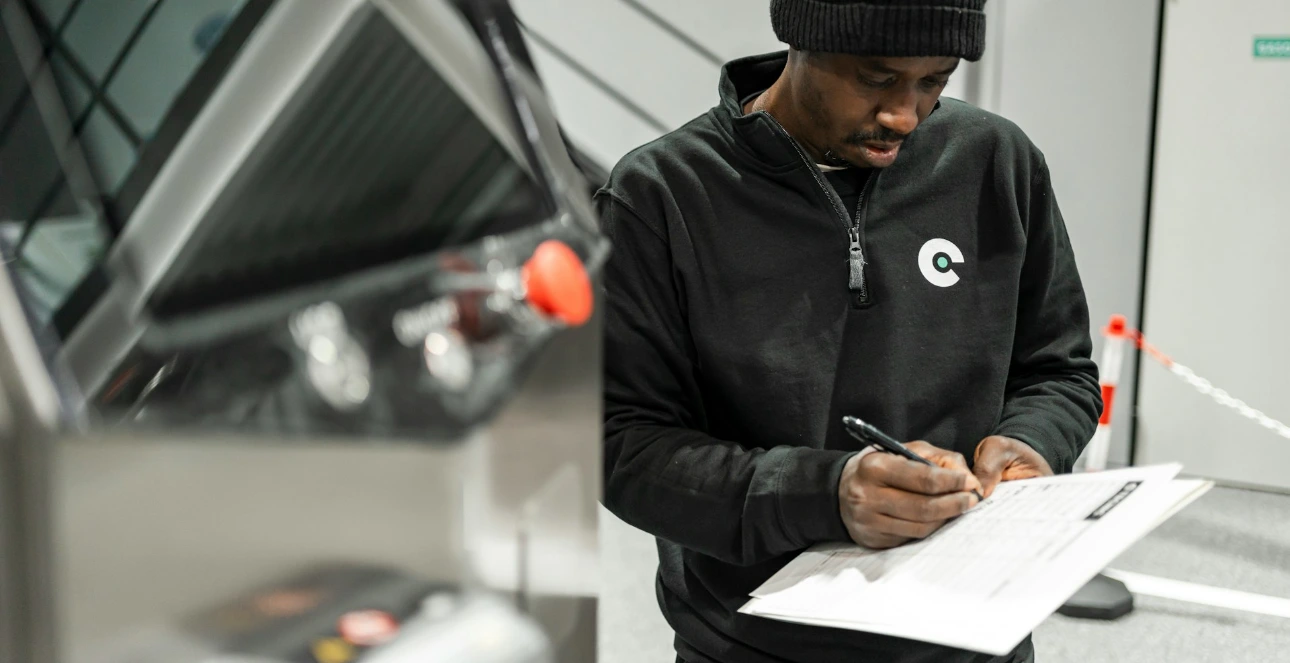 A man is writing by a machine