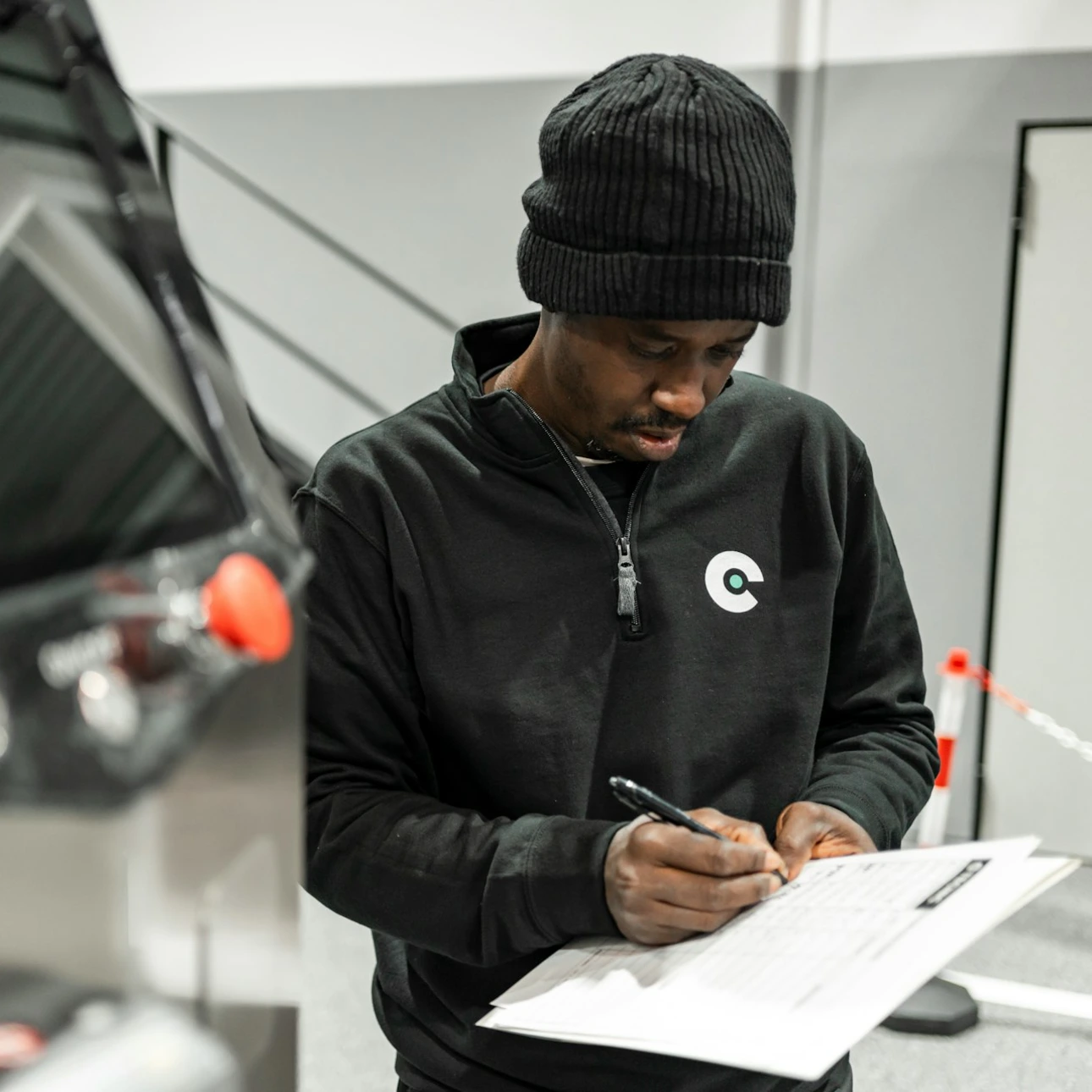 A man is writing by a machine