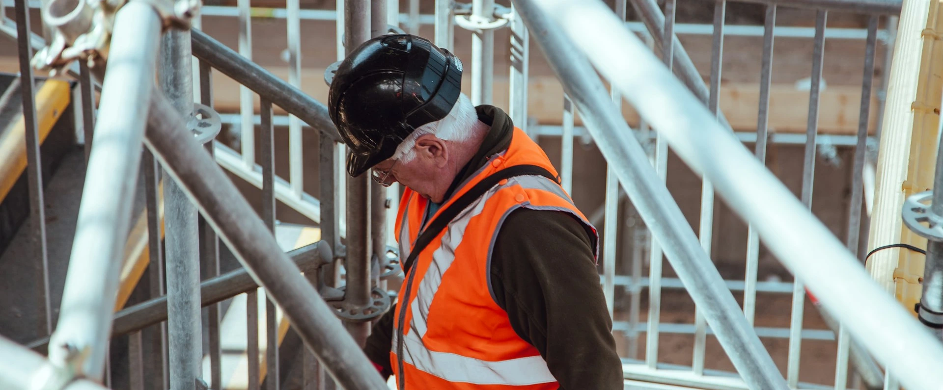 man standing under scaffoldings