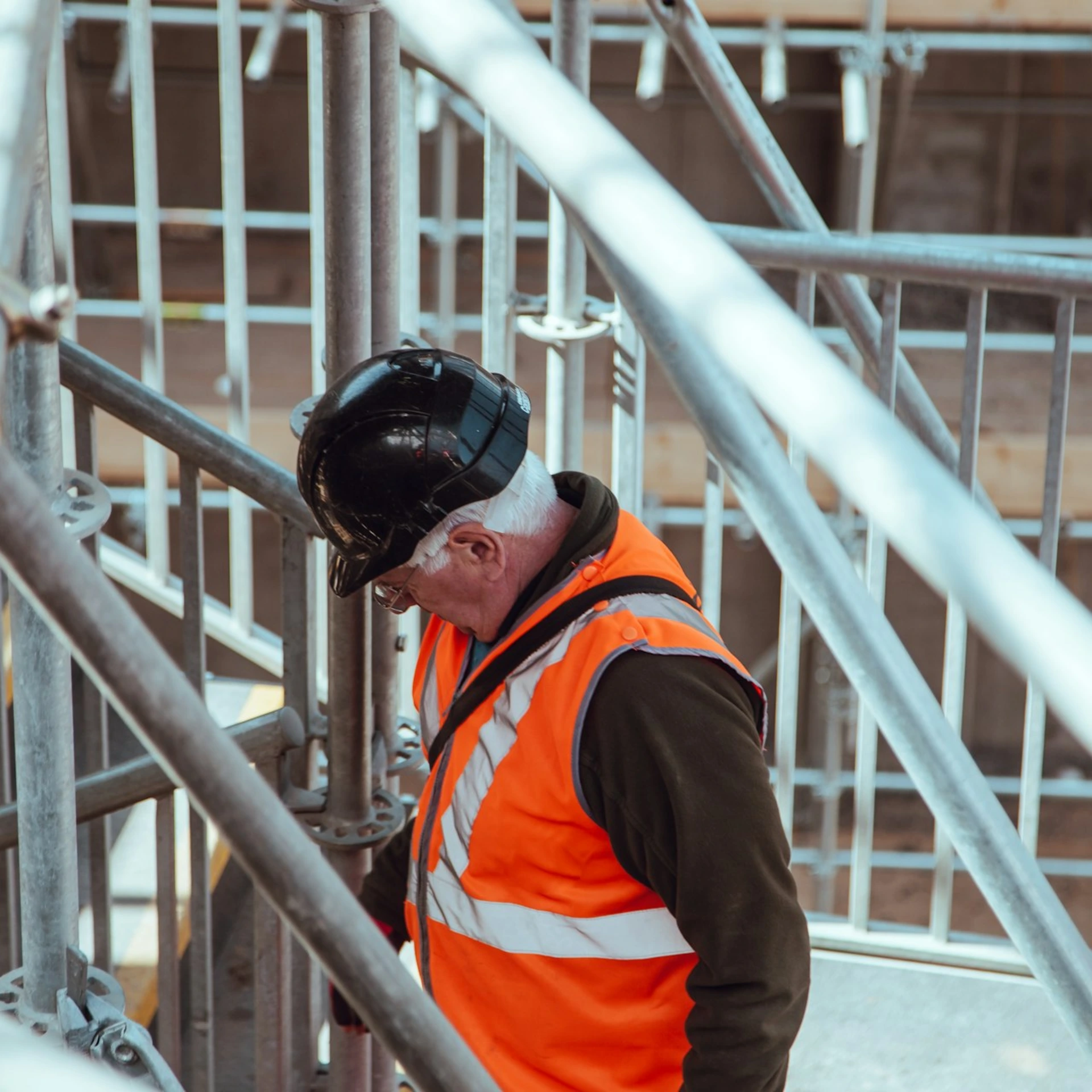man standing under scaffoldings
